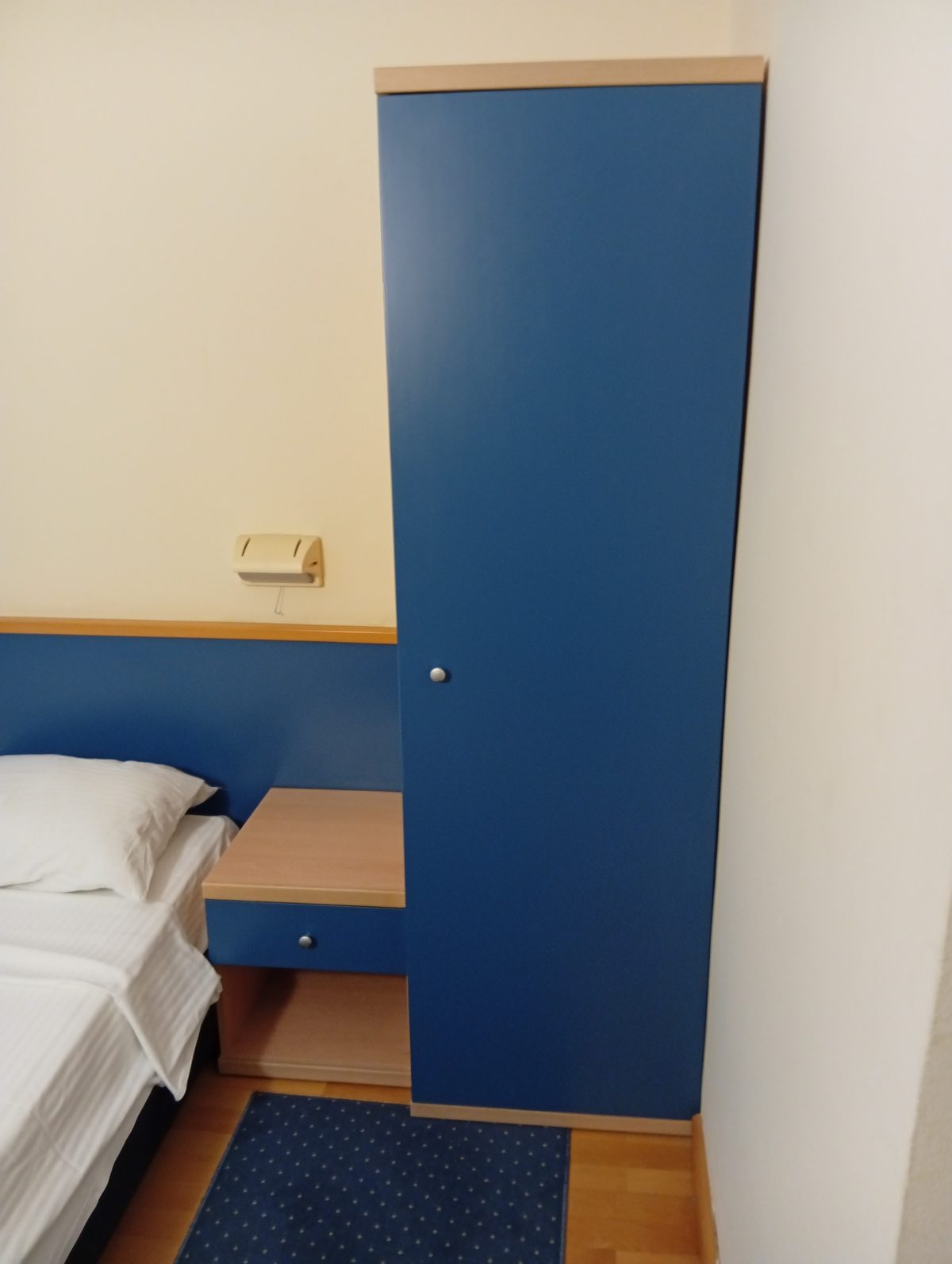 Wardrobe with hangers and spare bedding