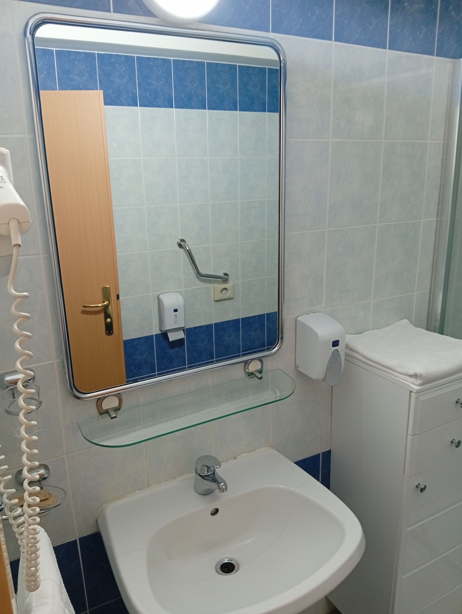 Bathroom sink, mirror and hairdryer