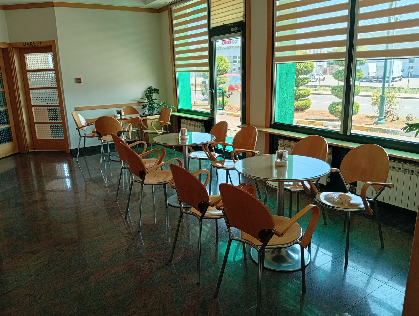 Kafe Bar — café tables by the windows